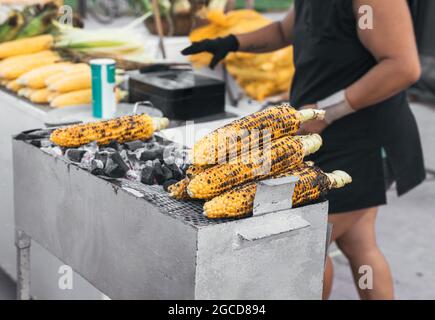 Some roasted corncobs at a street food stall Stock Photo