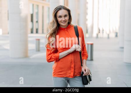 Young caucasian woman in the city smiling at the camera. Stock Photo
