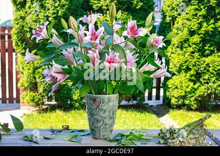 Huge bouquet of lilies in the garden. Summer party Stock Photo