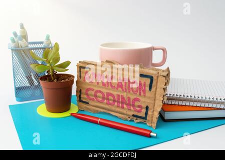 Handwriting text Application Coding. Concept meaning process by which a mobile app is developed for mobile Tidy Workspace Setup Writing Desk Tools And Stock Photo
