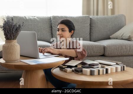 Indian female designer work on computer at home office Stock Photo
