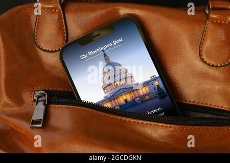 The Washington Post on Apple iPhone 12 Pro Max. Washington, D.C. based US American newspaper, WP logo on smartphone display. Business bag. Stock Photo