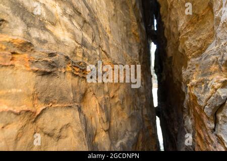 insight into a crevice of sandsone rocks abstract orange colored stone texture Stock Photo