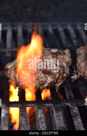 Beef hamburger cooking on a gas grill Stock Photo