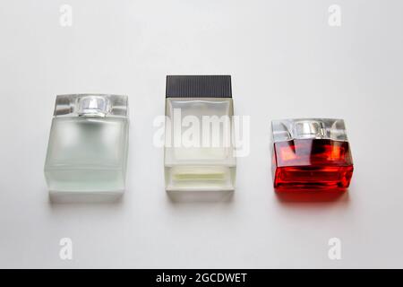 Three rectangular glass perfume bottles isolated on white background Stock Photo