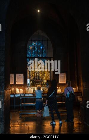 Maastricht, Netherlands - June 2021: altar and candles with worshippers in the Basilica of Our Lady Stock Photo