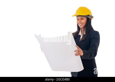 portrait of asian engineer woman with helmet holding blueprints isolated white background with copy space Stock Photo