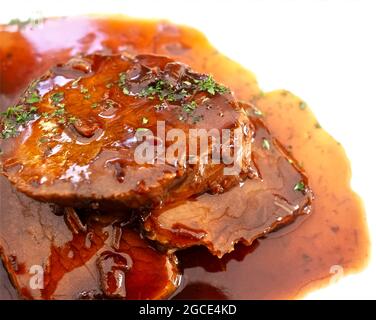 Delicious cooking: Roast beef with sauce on a plate Stock Photo