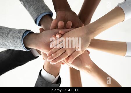 Close up of diverse people stack hands for shared success Stock Photo