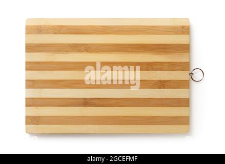Striped wooden cutting board isolated on white background. New bamboo chopping board as design element. Modern kitchen utensils of natural materials. Stock Photo