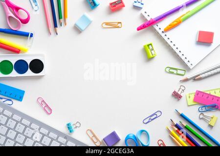 Flat lay colorful school supplies on white background. Back to school concept. Top view, overhead. Stock Photo