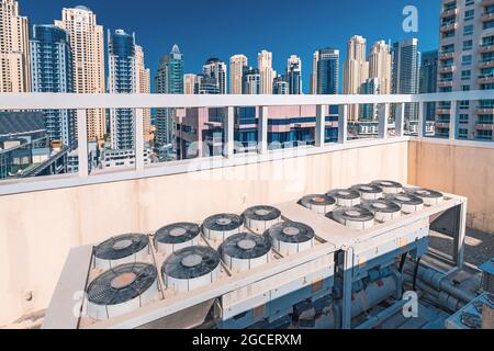 Worn and old ventilation and air conditioning system on the roof of a skyscraper building. Climate control and engineering control Stock Photo