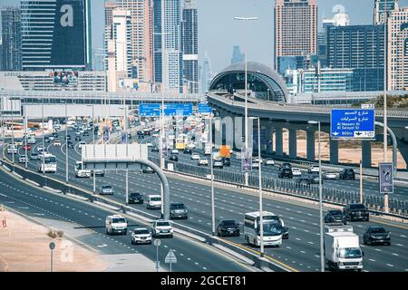 23 February 2021, Dubai, UAE: Aerial view of the famous Sheikh Zayed Road with heavy traffic and metro and tram rails and numerous highrise buildings Stock Photo