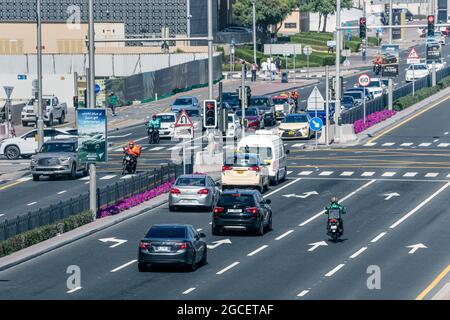 23 February 2021, Dubai, UAE: View of a car intersection with cars and scooters. Stock Photo