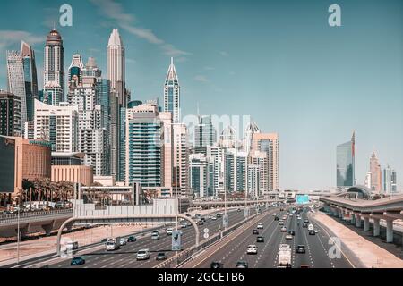 23 February 2021, Dubai, UAE: Aerial view of the famous Sheikh Zayed Road with heavy traffic and metro rails and numerous skyscrapers in Dubai Marina Stock Photo