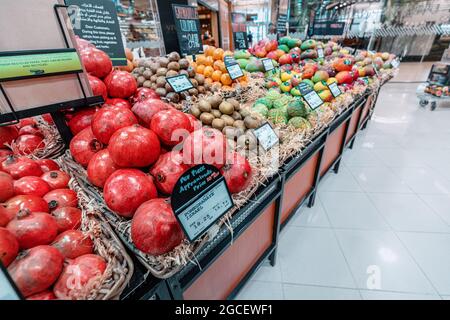 23 February 2021, Dubai, UAE: Ripe Pomegranate from Israel with a price tag in dirhams is sold in a supermarket in Dubai Stock Photo