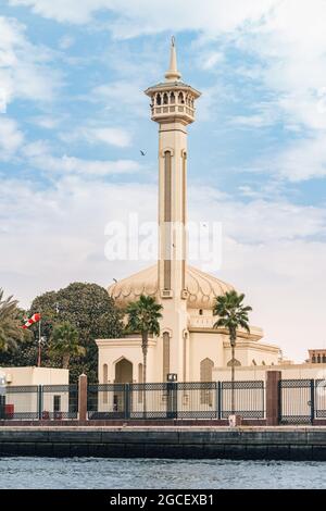 Famous Al Farooq mosque minaret view from Dubai Creek Canal. Tourist and religious destinations in UAE Stock Photo