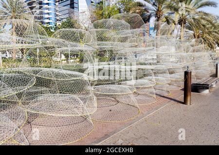 Many metal nets for catching shrimps and lobsters are waiting for fishing vessels on the pier. Seafood industry concept Stock Photo