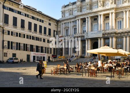 People sitting in an outdoor cafè in front of the Palazzo Ducale in the historic centre of Genoa, Liguria, Italy Stock Photo