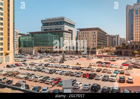 24 February 2021, Dubai, UAE: Large filled open-air parking lot with hundreads of cars near the hotel and business center in Dubai Stock Photo