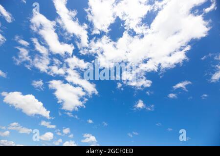A beautiful blue sky with a few clouds create the perfect sky replacement for Photoshop 2021. Stock Photo