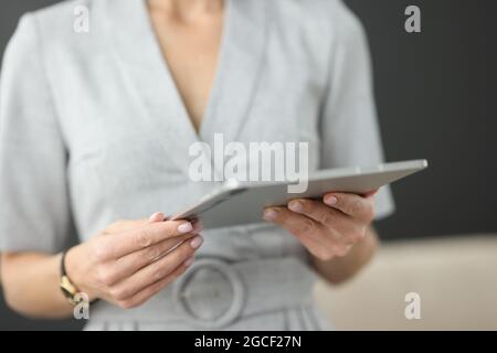 Businessman is holding modern tablet in hands while studying new app Stock Photo