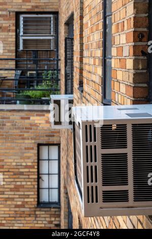 Window mounted air conditioners are used in New York City buildings that do not have central air, United States Stock Photo