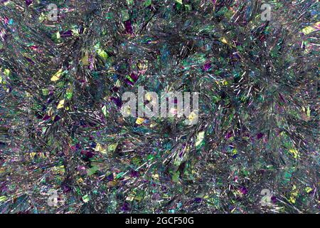 Dark silver Christmas tinsel background. Silvery background and beautiful bokeh. Stock Photo