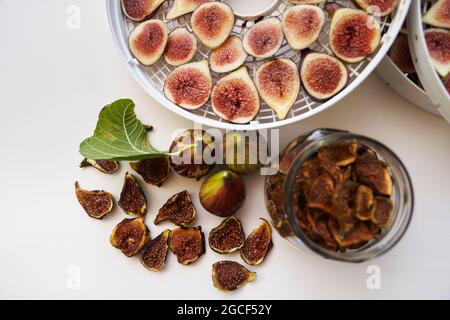 Fresh figs lie on the table next to dried figs. Top view Stock Photo
