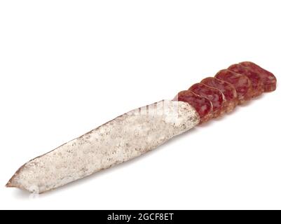 Traditional Spanish Fuet thin dried sausage with slices, Close-up, isolated on a white background Stock Photo