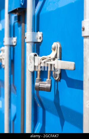 Container close-up. Blue cargo container with a lock. The concept of the increased cost of freight. Banner with place for text. Stock Photo