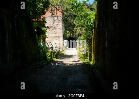 A Dark Tunnel with a View of the Other on a Sunny Day in Amaga, Antioquia, Colombia Stock Photo