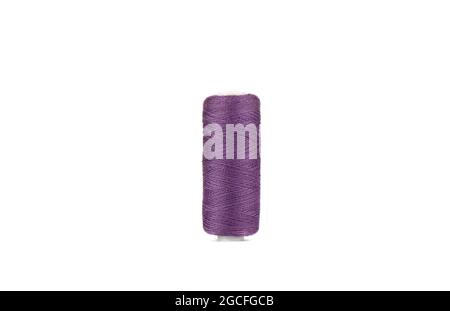 Spool of thread in purple color isolated on white background. Copy space. Stock Photo