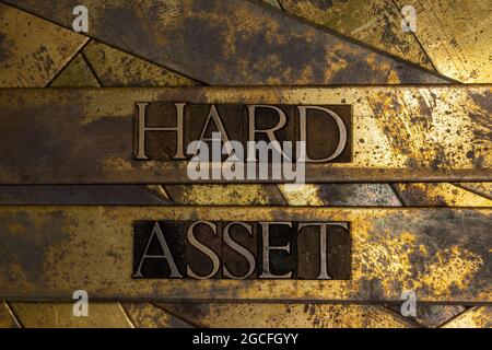 Hard Asset text on textured grunge copper and vintage gold background Stock Photo