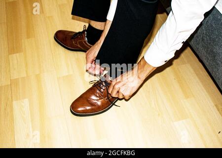 Businessman clothes shoes, man getting ready for work, groom in the morning before the wedding ceremony. Stock Photo