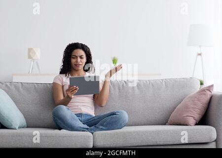 Connect problems, bad news, new normal, social distancing, covid-19 quarantine. Disgruntled displeased unhappy millennial african american woman upset Stock Photo