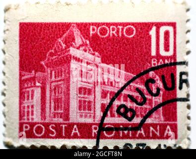 An old used postage stamp printed in Romania shows Central Post Office building (National museum of Romanian history now), value 10 Bani, pink edition Stock Photo