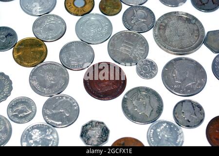 Background of various coins from many countries and different values isolated on white background, vintage retro, old coins background Stock Photo