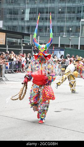 People dressed as Diablos Cojuelos attend the Dominican Day Parade on August 8, 2021 on the Avenue of the Americas in New York, New York. Robin Platzer/ Twin Images/ Credit: Sipa USA/Alamy Live News Stock Photo