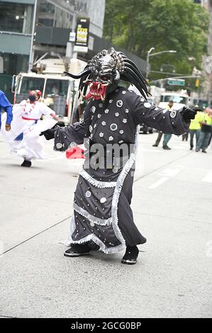 People dressed as Diablos Cojuelos attend the Dominican Day Parade on August 8, 2021 on the Avenue of the Americas in New York, New York. Robin Platzer/ Twin Images/ Credit: Sipa USA/Alamy Live News Stock Photo