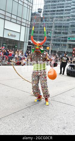 People dressed as Diablos Cojuelos attend the Dominican Day Parade on August 8, 2021 on the Avenue of the Americas in New York, New York. Robin Platzer/ Twin Images/ Credit: Sipa USA/Alamy Live News Stock Photo