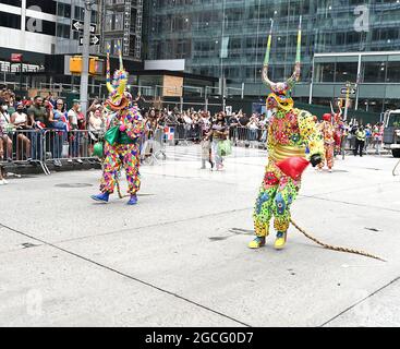 People dressed as Diablos Cojuelos attend the Dominican Day Parade on August 8, 2021 on the Avenue of the Americas in New York, New York. Robin Platzer/ Twin Images/ Credit: Sipa USA/Alamy Live News Stock Photo