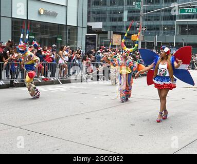 People dressed as Diablos Cojuelos attend the Dominican Day Parade on August 8, 2021 on the Avenue of the Americas in New York, New York. Robin Platzer/ Twin Images/ Credit: Sipa USA/Alamy Live News Stock Photo