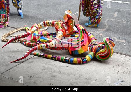 People dressed as Diablos Cojuelos attend the Dominican Day Parade on August 8, 2021 on the Avenue of the Americas in New York, New York. Robin Platzer/ Twin Images/ Credit: Sipa USA/Alamy Live News Stock Photo