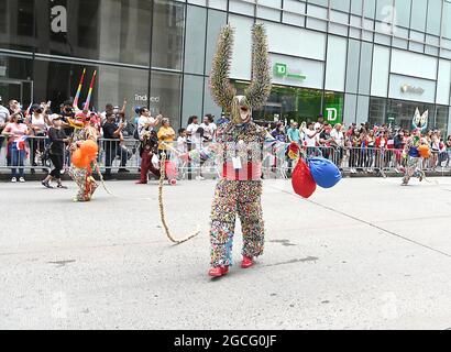 People dressed as Diablos Cojuelos attend the Dominican Day Parade on August 8, 2021 on the Avenue of the Americas in New York, New York. Robin Platzer/ Twin Images/ Credit: Sipa USA/Alamy Live News Stock Photo