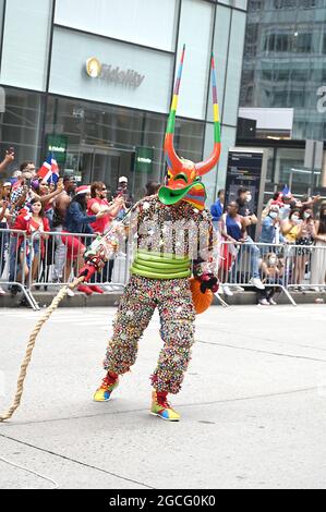 People dressed as Diablos Cojuelos attend the Dominican Day Parade on August 8, 2021 on the Avenue of the Americas in New York, New York. Robin Platzer/ Twin Images/ Credit: Sipa USA/Alamy Live News Stock Photo