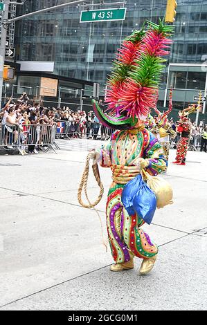 People dressed as Diablos Cojuelos attend the Dominican Day Parade on August 8, 2021 on the Avenue of the Americas in New York, New York. Robin Platzer/ Twin Images/ Credit: Sipa USA/Alamy Live News Stock Photo