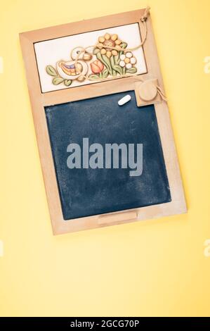 A top view of a small wall chalkboard for schedules on orange background with a copy space Stock Photo