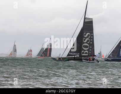 Cowes Isle of Wight, UK. 8th August 2021. Rolex Fastnet; Hugo Boss , IMOCA 60 heading out of the Solent in 35 knots of  wind at the start of the Fastnet Race. Credit Gary Blake /Alamy Live News Stock Photo