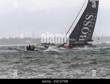 Cowes Isle of Wight, UK. 8th August 2021. Rolex Fastnet; Hugo Boss , IMOCA 60 heading out of the Solent in 35 knots of  wind at the start of the Fastnet Race. Credit Gary Blake /Alamy Live News Stock Photo